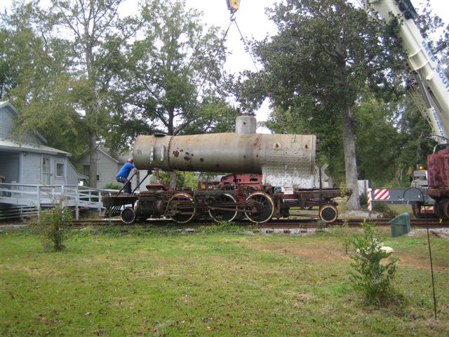 The front of the boiler lifts first. It appears as if the man in front is trying to hold it down.