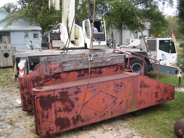 The water tank is safely placed onto crossties to await its turn at repair, sandblasting and painting.