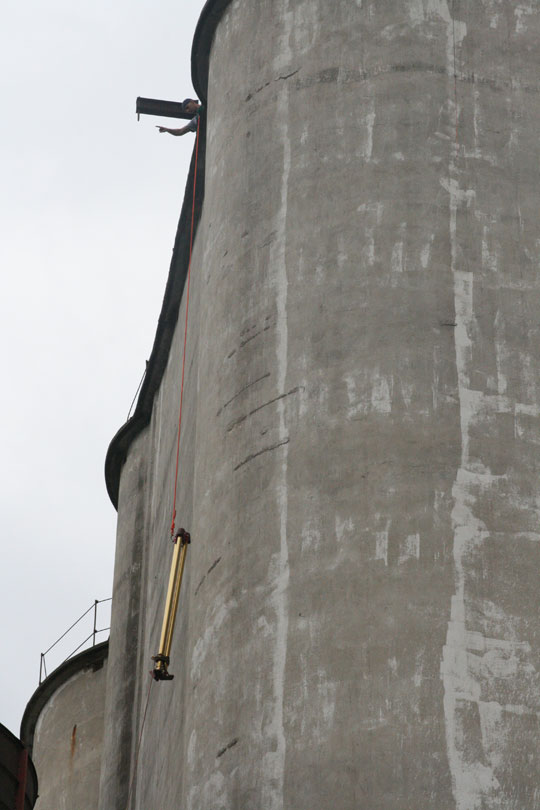 Equipment Being Pulled Up Side Of Silo
