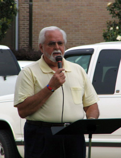 Rev. Haskell Dunn praying for churches
