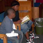 Middle School Student Reads To Elementary Student