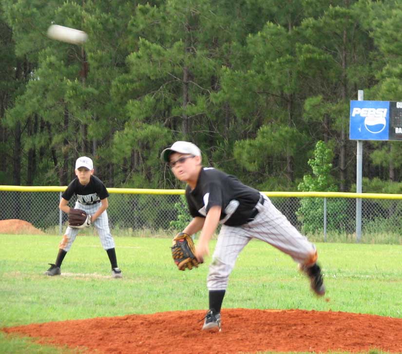 Zach Payne delivers with Devin Stabler covering center field